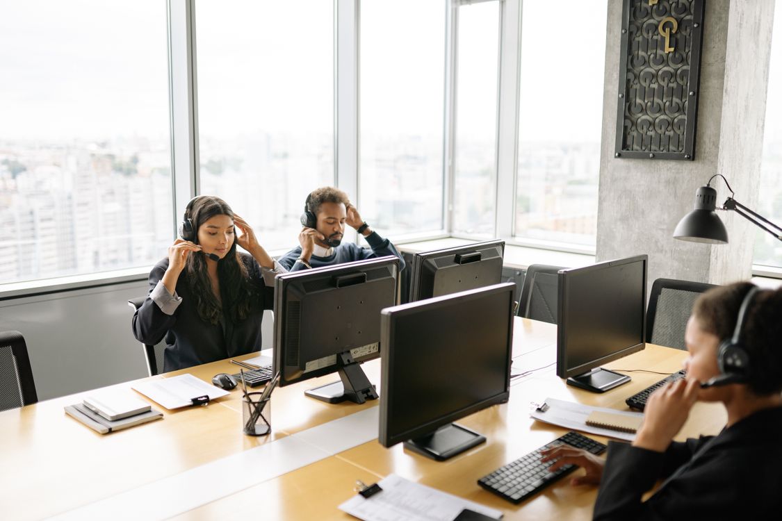 IT support professionals at helpdesk workstations