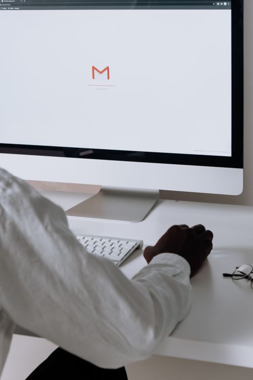 Professional reviewing email on a desktop computer
